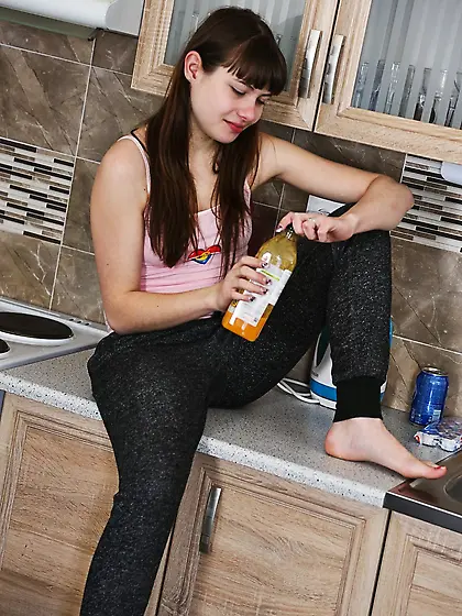 Teen satisfies her thirst and begins to take off clothes in the