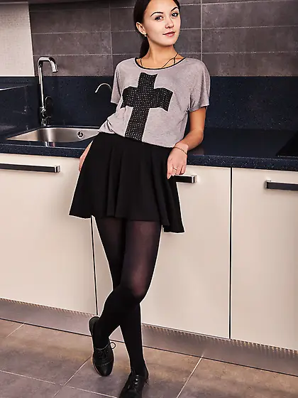 Skinny brunette takes off her cross t-shirt and gets naked in th