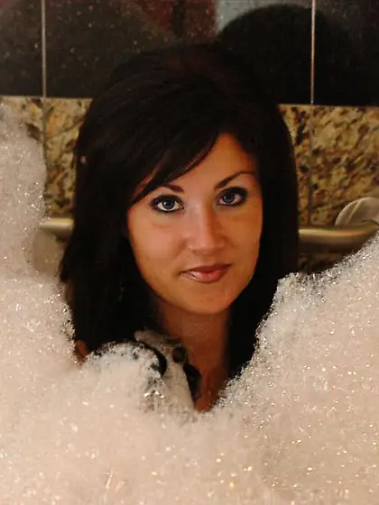 Slutty brunette bitch Sweet Krissy poses in the shower and shows