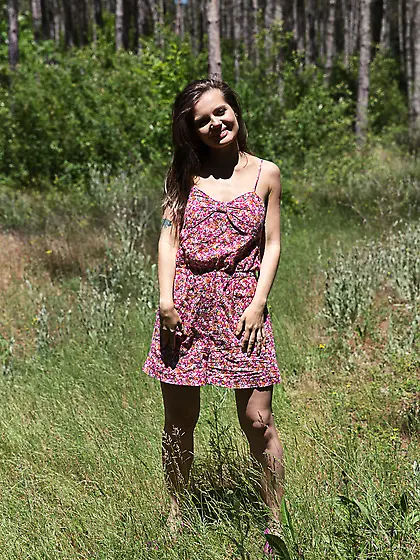 Adorable bimbo enjoys displaying naked body during walk in the f