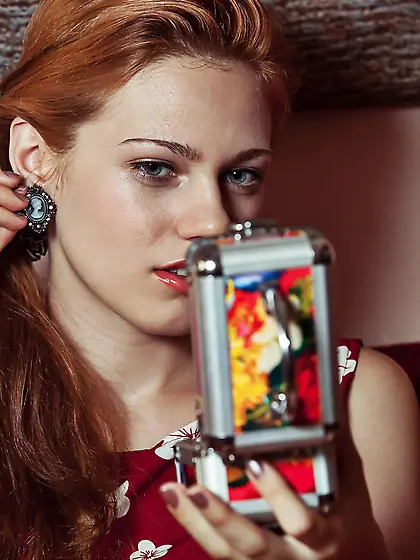 Redheaded cutie dressed in red decides to show her pussy on a co