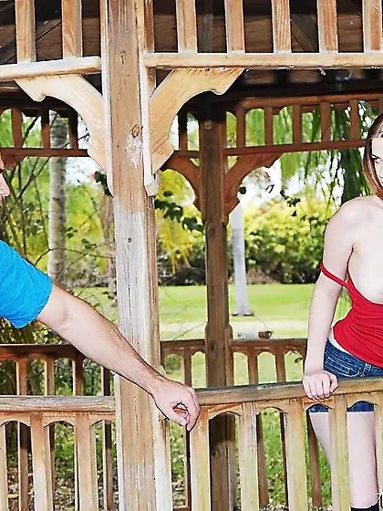 Hot red babe puts a penis in her mouth in this cozy gazebo