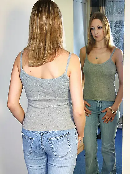 Amateur sweetheart Laura puts her panties and stockings on in th