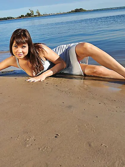 Wet chick in sexy swimwear exposing her gorgeous pussy on a beac