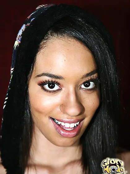 Latina bimbo Aliana Love smiles playing with cock sticking out o