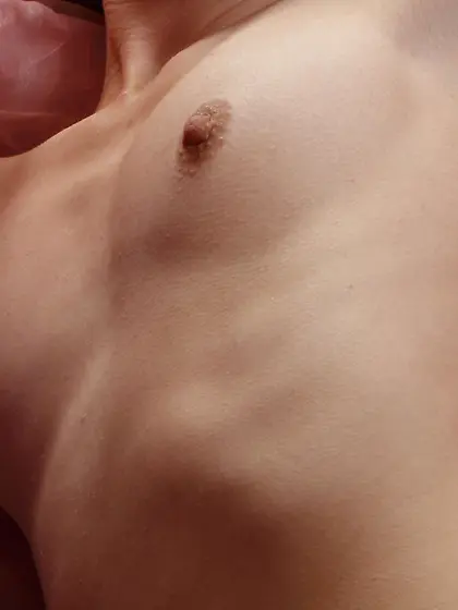 Flat-chested brunette gets on all fours on a huge pink bed in HQ