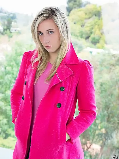 Hottie in a pink coat takes panties down exposing smooth pussy o