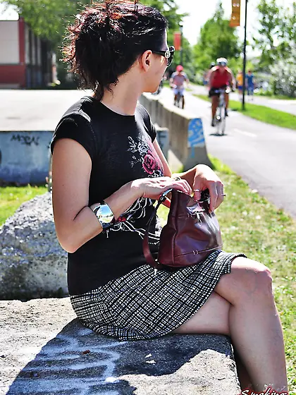 Brunette babe smoking at the park