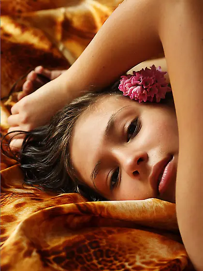 Truly beautiful young porn model Irina J is lying on the bed and