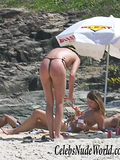 Charlize Theron topless on a beach