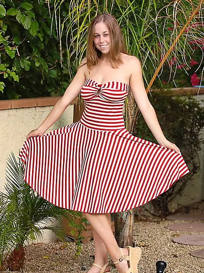 Wearing a red candy cane print dress Carly Kaleb gives the hot p