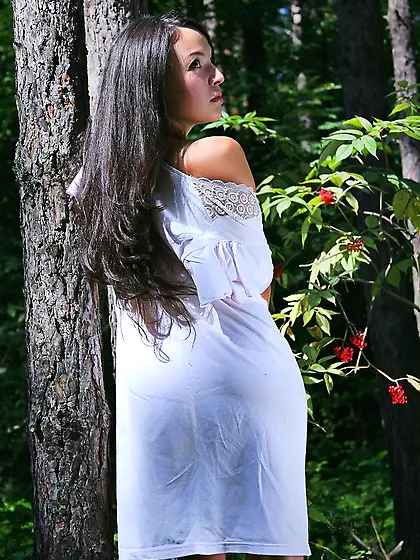 Dark-haired girl with a pretty face posing totally naked in the