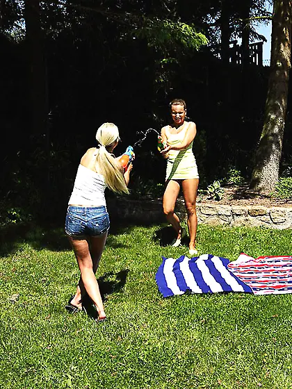 Friends have fun with water guns and can't resist practicing les