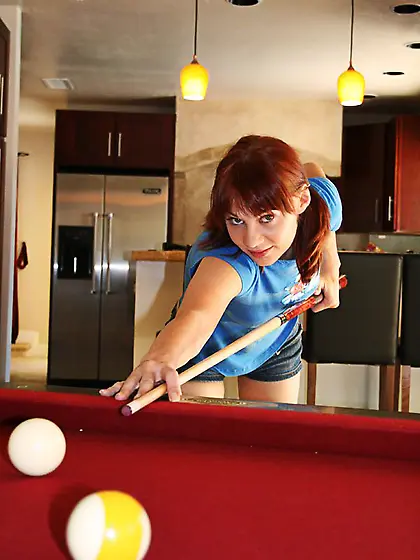 Red-haired cutie plays pool with her dude.  Sure,  she loses and s
