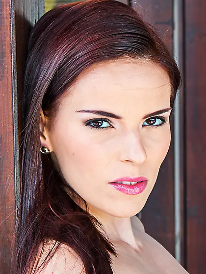 Brunette girl pink stands