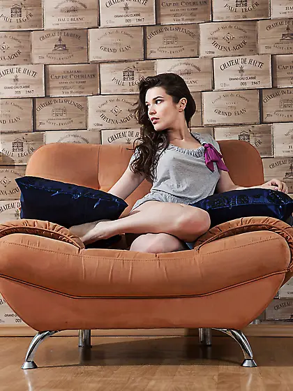 Dark-haired and pale-looking teen brunette spreads her sexy legs