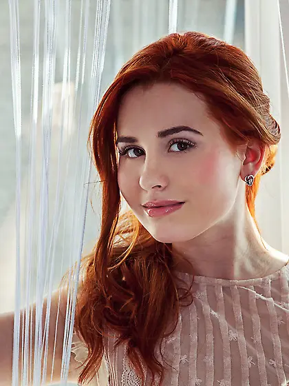 Redhead peeling off her black panties and teasing with her booty