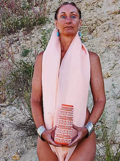 With vase in hands and yellow shawl