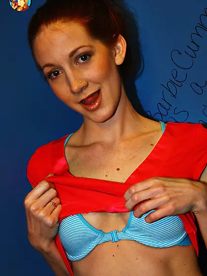 Skinny redhead undresses before polishing black dong via hole in