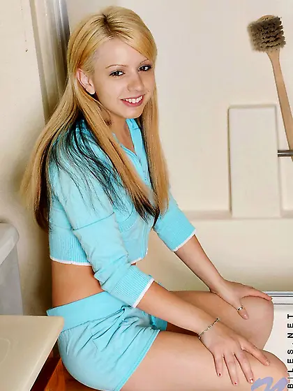 Naughty teenie Lexi Belle removes her blue suit and displays her