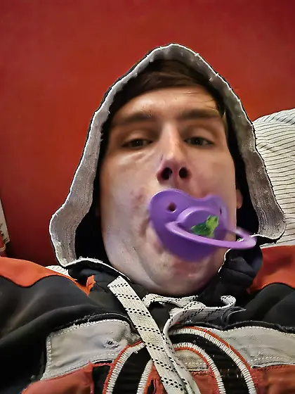 Alex wears diapers and pacifiers