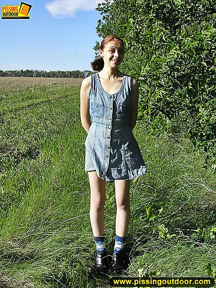 Pissing outdoor on a green grass