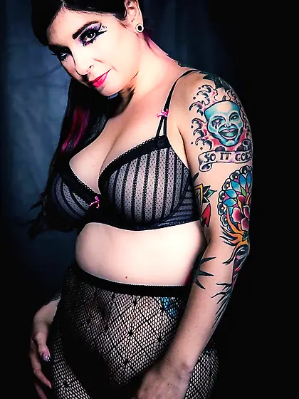 Busty brunette illuminates a dark room with her naked tits and t