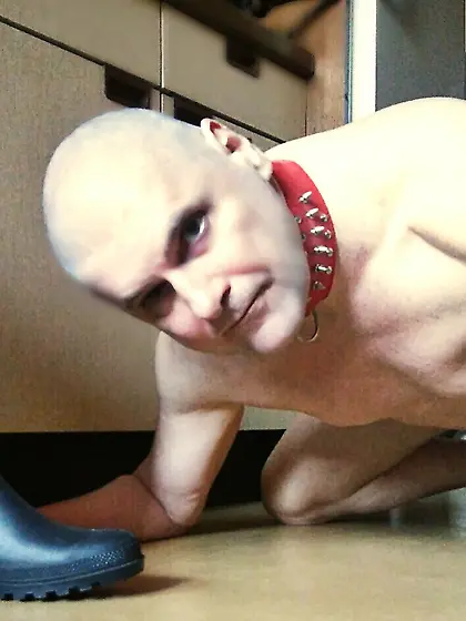 bald head shaved slave under the bdsm bootmaster