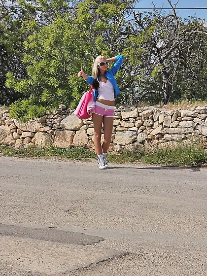 Cute blonde hitchhiker Bambi shows her tits in a car and poses i