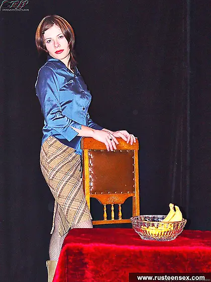 Teen brunette plays with banana