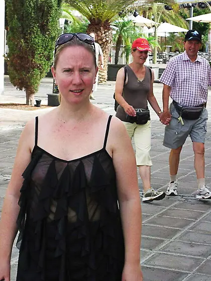 In a frilly black top on the street