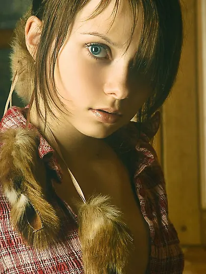 Young beauty with a flat belly posing in a cabin,  looking really