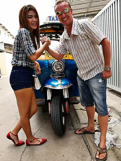 Eccentric white tourist poses with exotic babe outdoors near aut