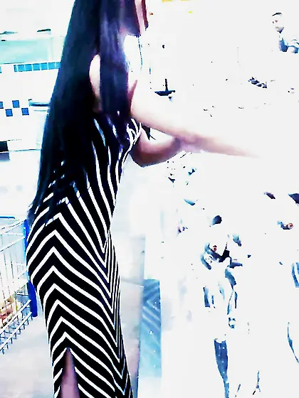 Sexy filipino babe in long striped skirt shopping for meat