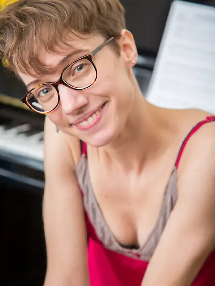 Ugly short-haired musician with glasses teases herself while pla