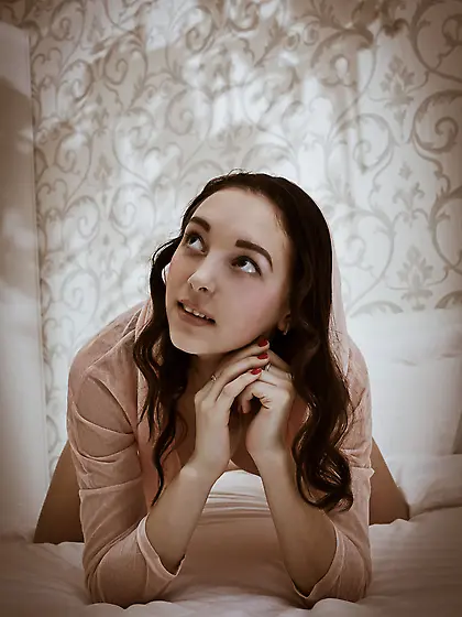 Curly-haired teen takes off her pink nightgown to pose completel