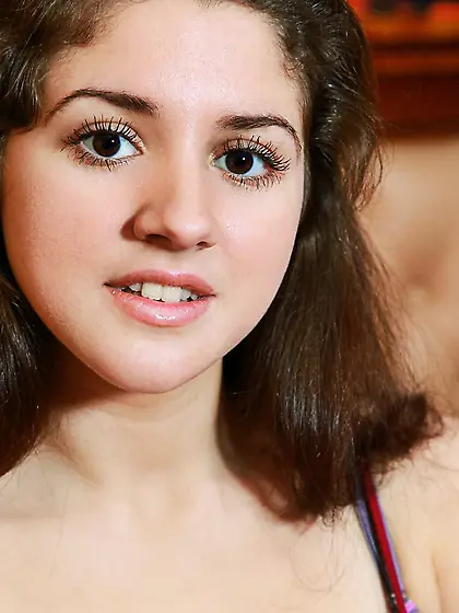 Heavy chested brunette babe Roxi plays with her massive boobs on