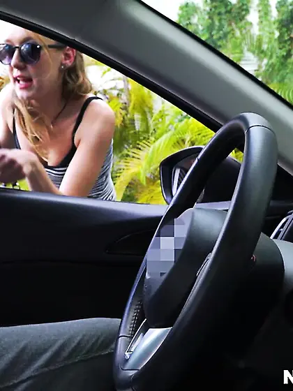 Lady reaches into a car to stroke driver's...