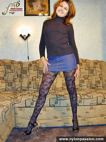 Teen blonde in black pantyhose posing