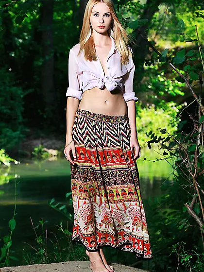 Long skirt blond-haired seductress posing completely naked outdo