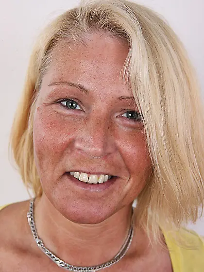 Photographer takes pictures of cheerful mature woman with blonde