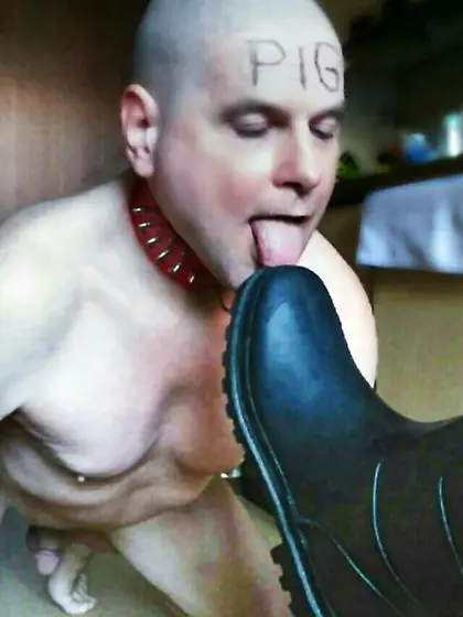 Slave tongue licks boot soles clean