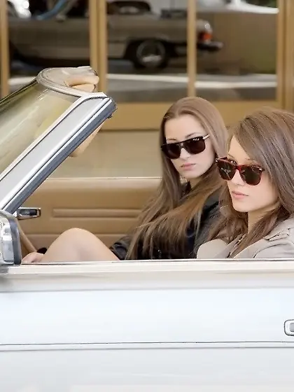 Cool lesbians ride a car and end up fucking each other on a bed