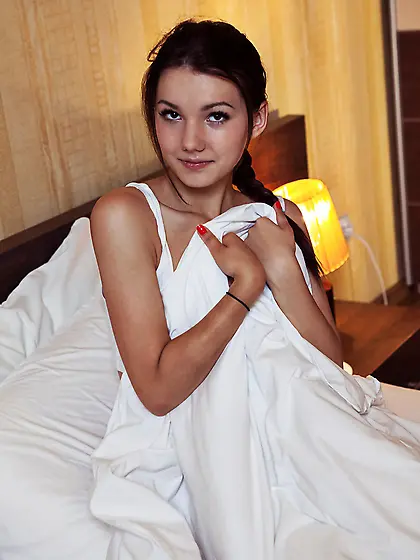 Playful young girl pulls her colorful panties half-way down,  enj