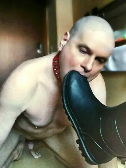 Slave tongue licks boot soles clean