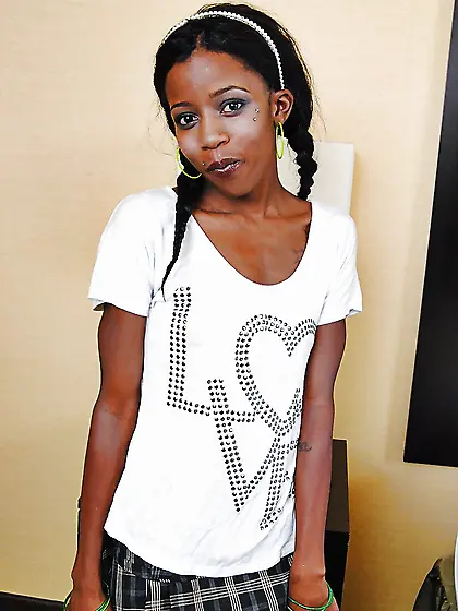 Cheerful black teen lifts her skirt to show off her pussy