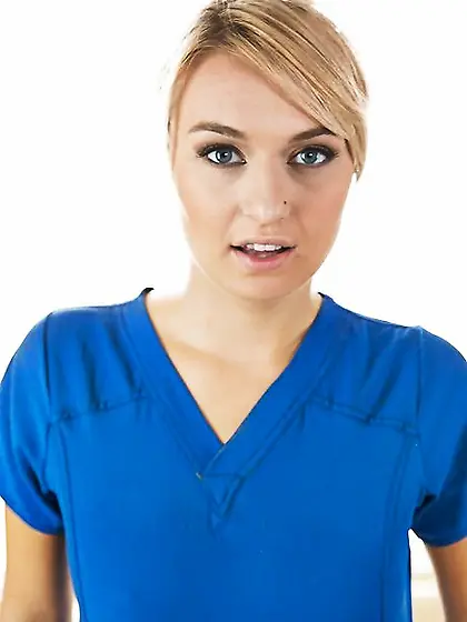 Hot blond masseuse poses on the massage table and pulls off her