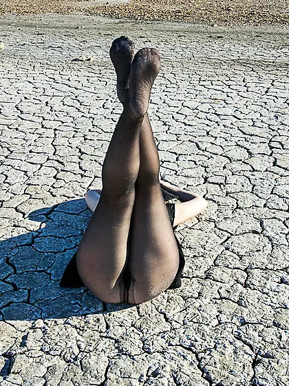 Torn and dirty feet in pantyhose outdoor