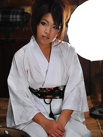 Cute young Japanese woman in a kimono participates in erotic pho