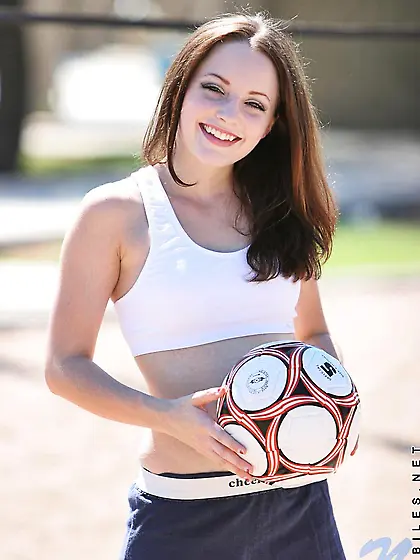 Smiling sportive girl Tabitha Nubiles in snow white top and blue